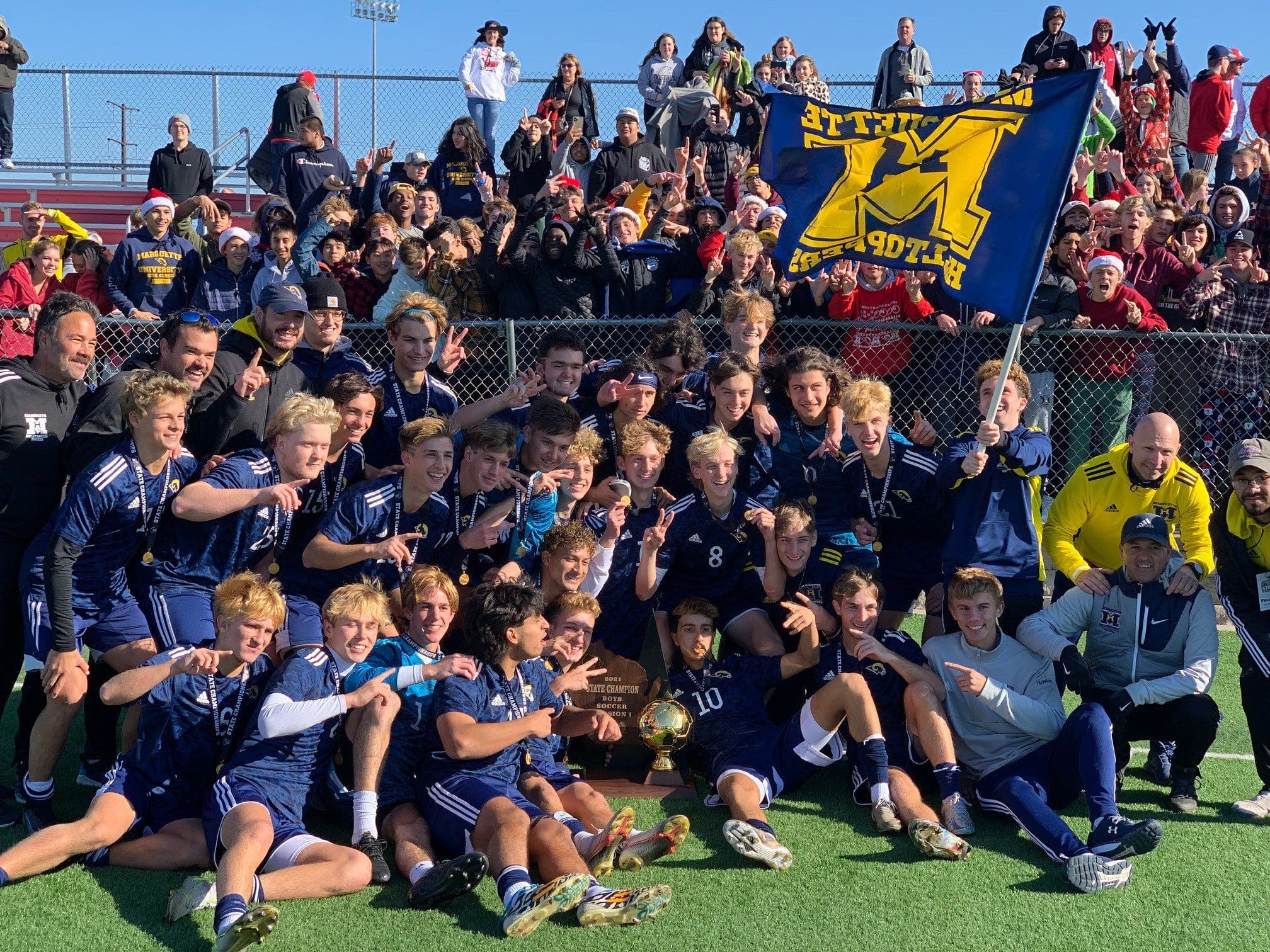 marq soc Marquette High School soccer team posing on field after winning 2021 state championship
